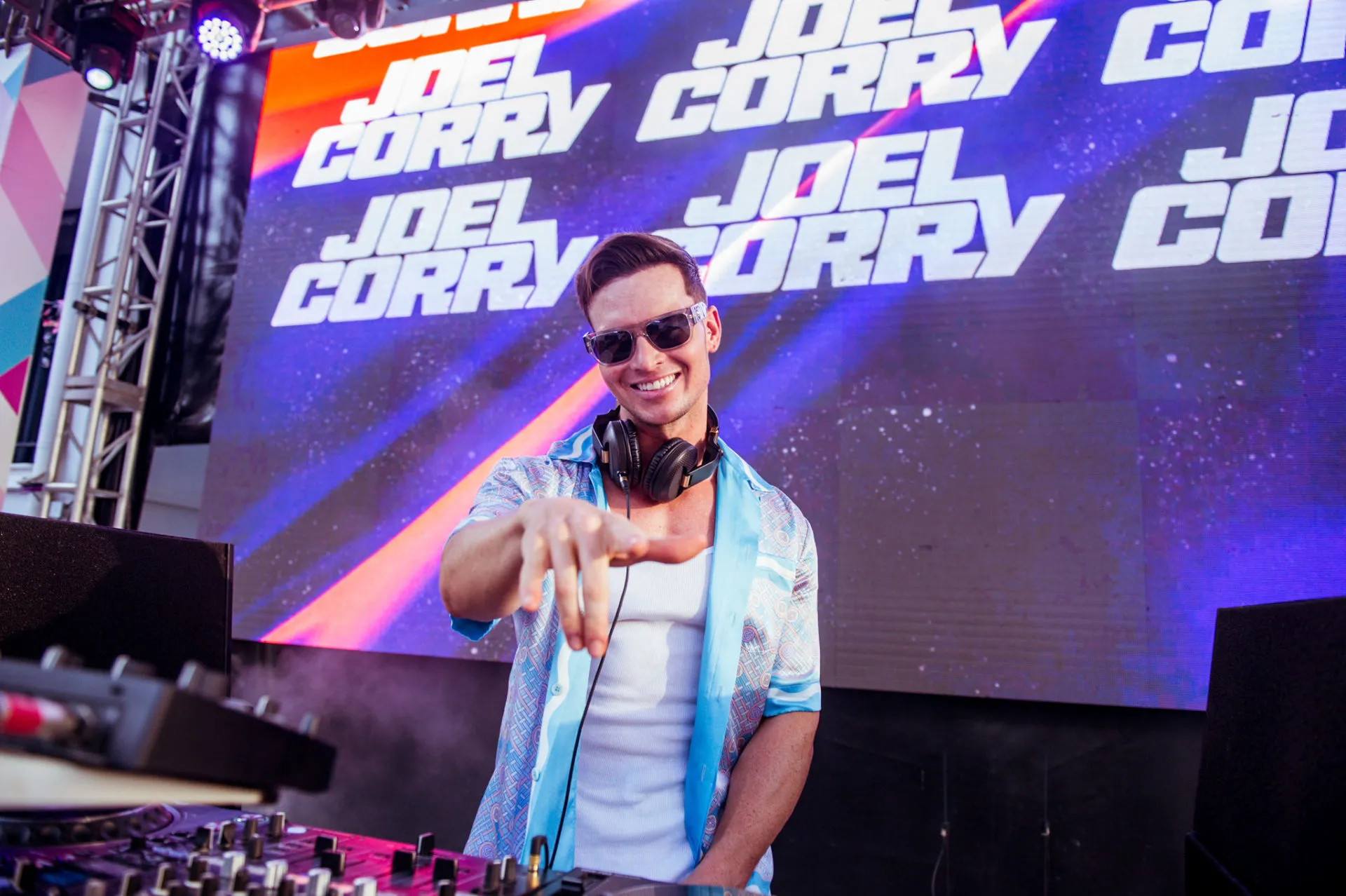 joel corry ibiza rocks pool party points to camera