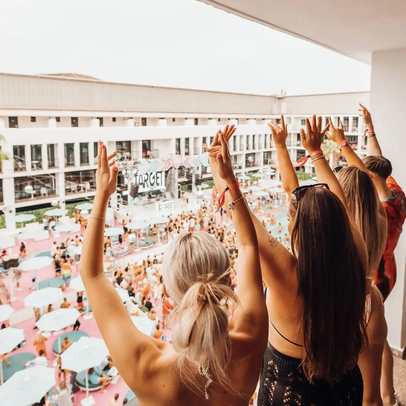 girls on venue view room balcony enjoying ibiza rocks pool party